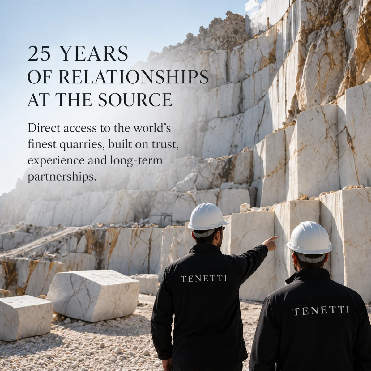 Two Tenetti team members assessing white marble blocks at a quarry